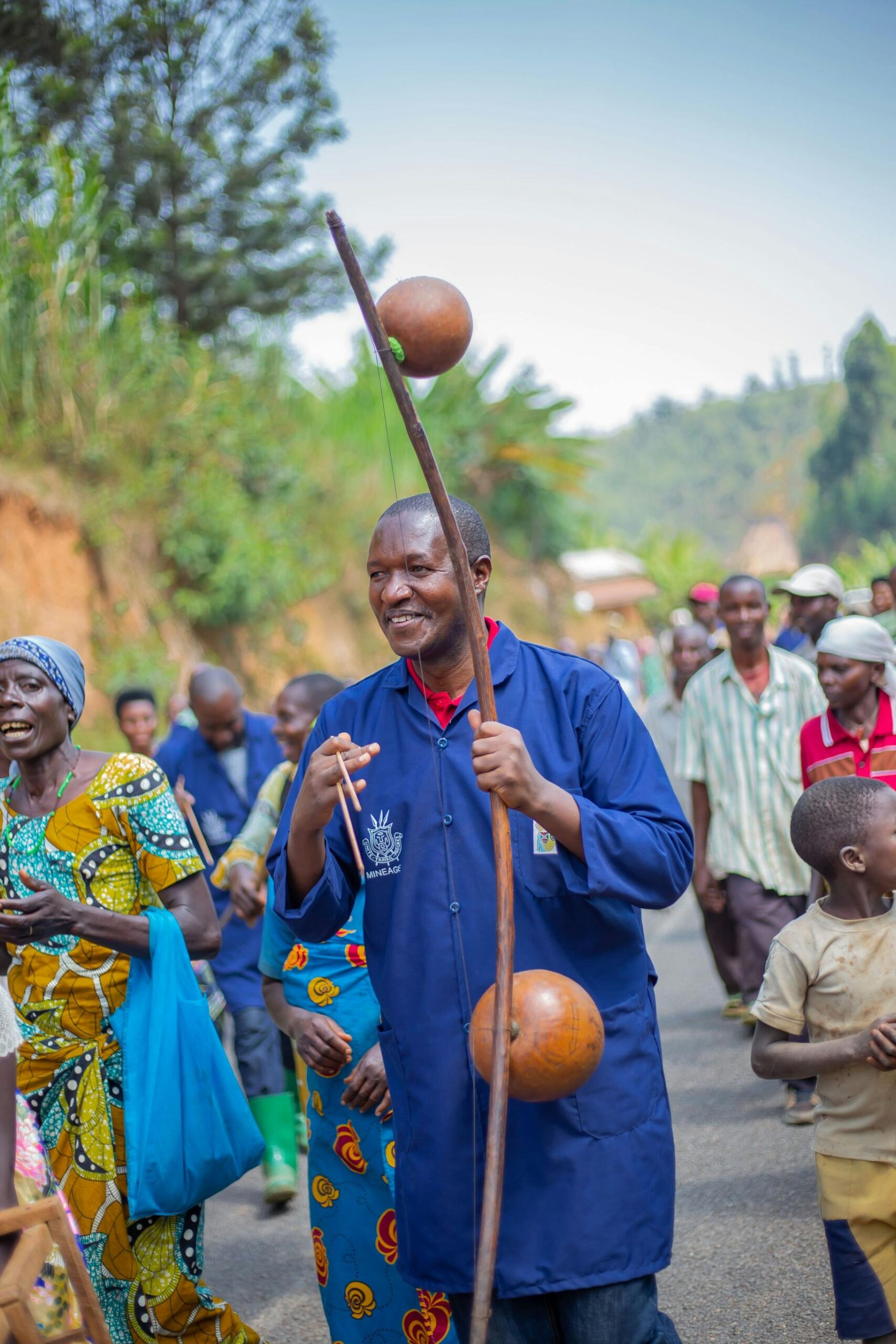 A group of people celebrating joyfully on a rural road, engaging in traditional festivities.